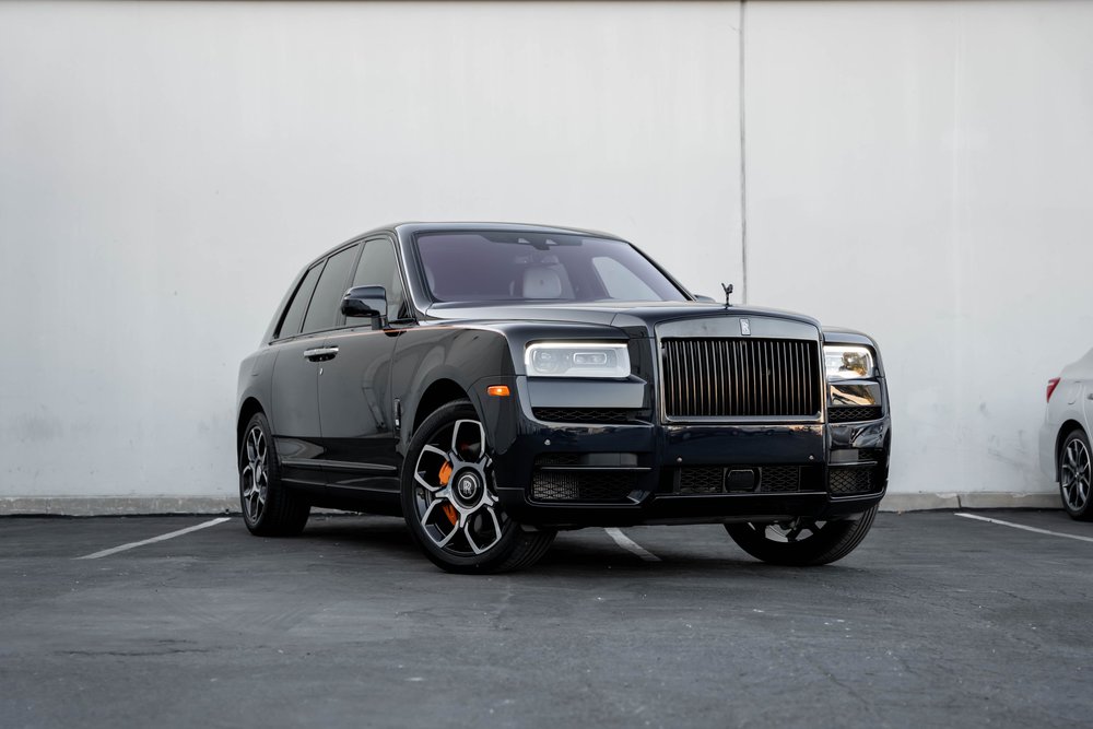 Black Rolls-Royce Cullinan Black Badge — complete front three-quarter landscape view showing the upright SUV body