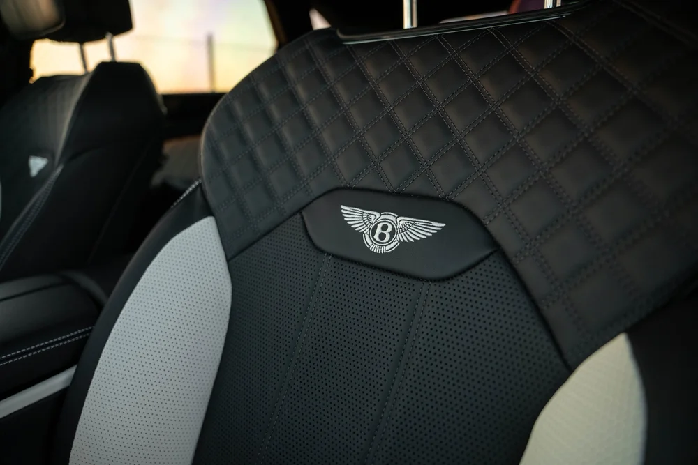 Bentayga front seat with diamond stitching and an embroidered winged Bentley emblem on the seat back