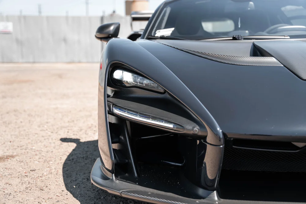 McLaren Senna headlight, front air intake and hood edge in close three-quarter view
