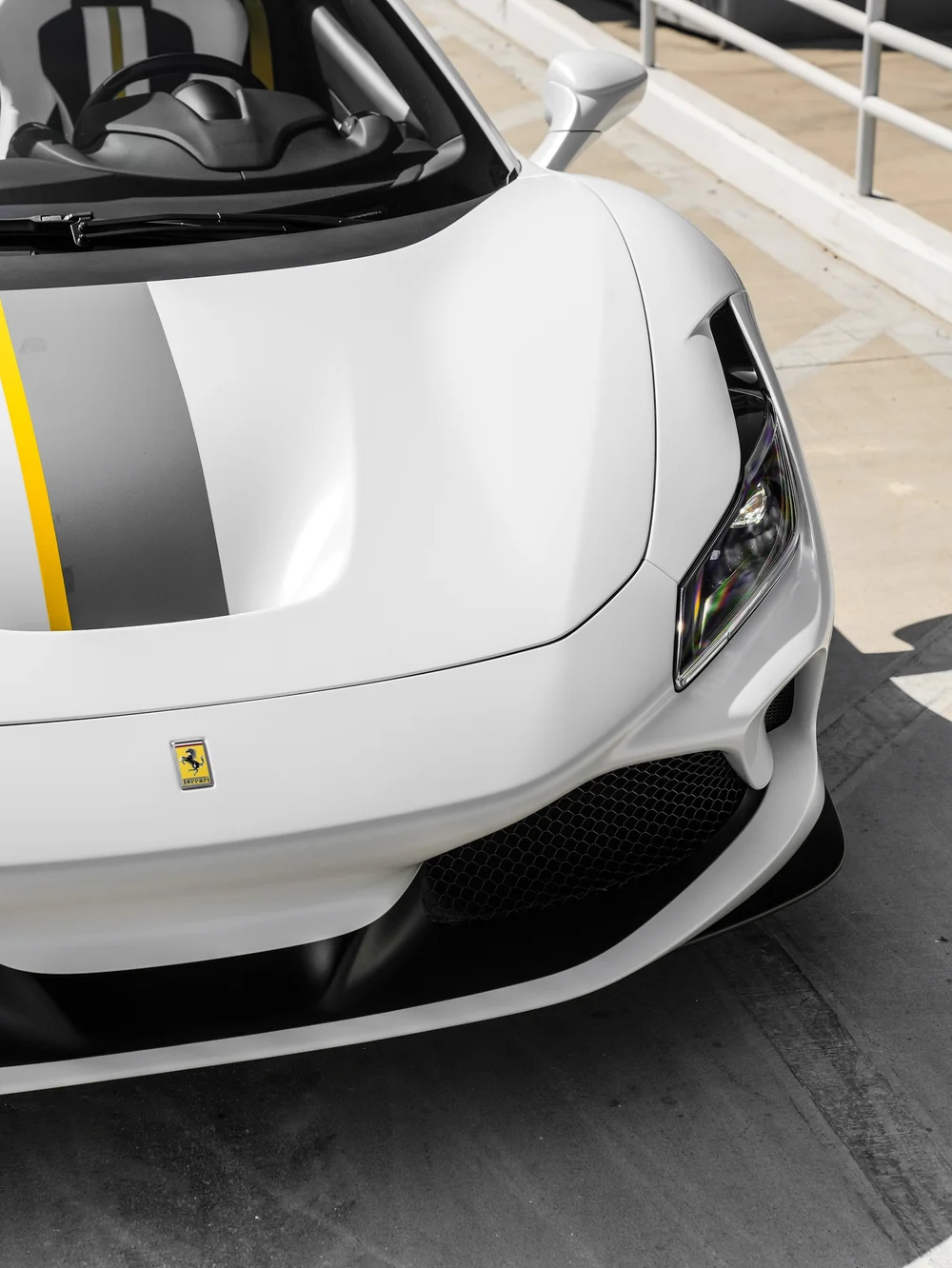 Ferrari F8 Spider hood and front corner showing the dark livery band and narrow yellow edge