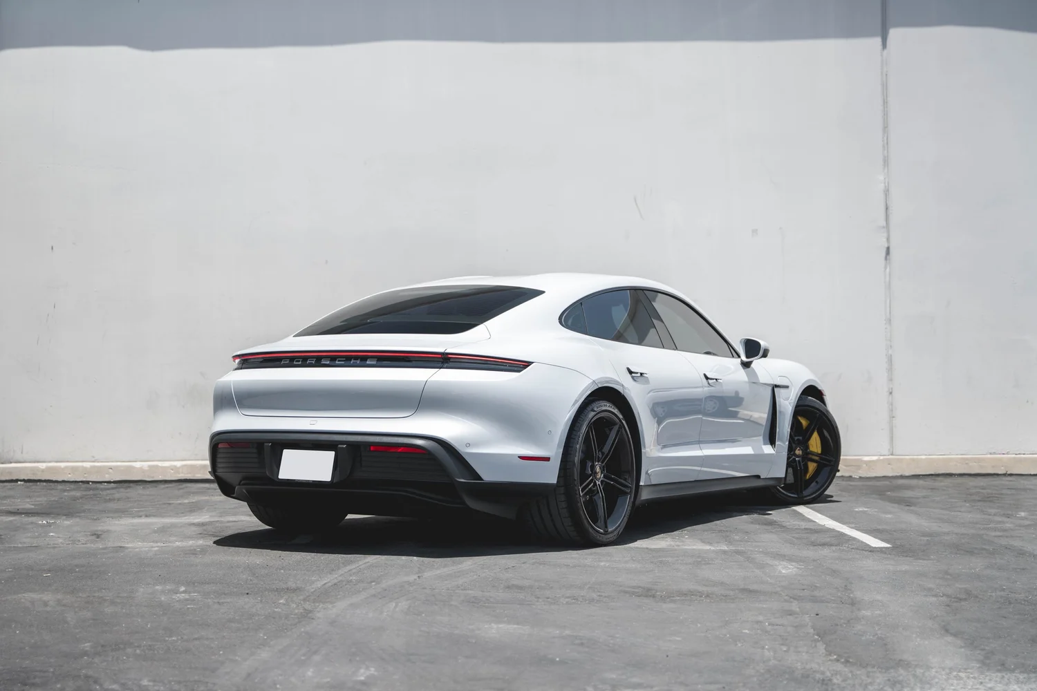 Porsche Taycan after Paint Protection Film (PPF), Window Tint and Ceramic Coating, rear-left three-quarter view