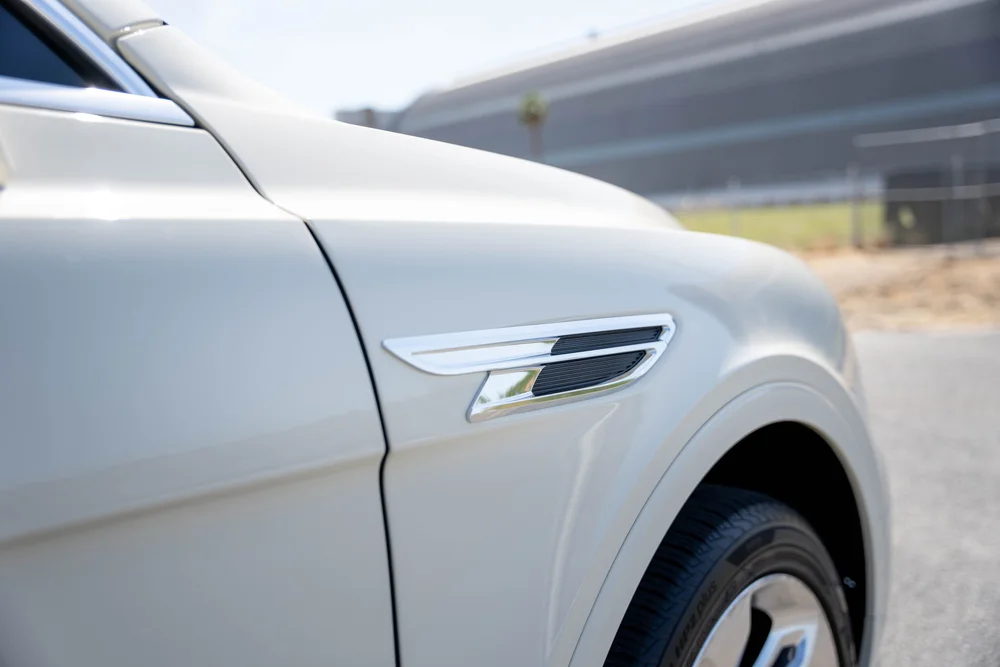 Close front-fender view showing the silver vent above the wheel arch.