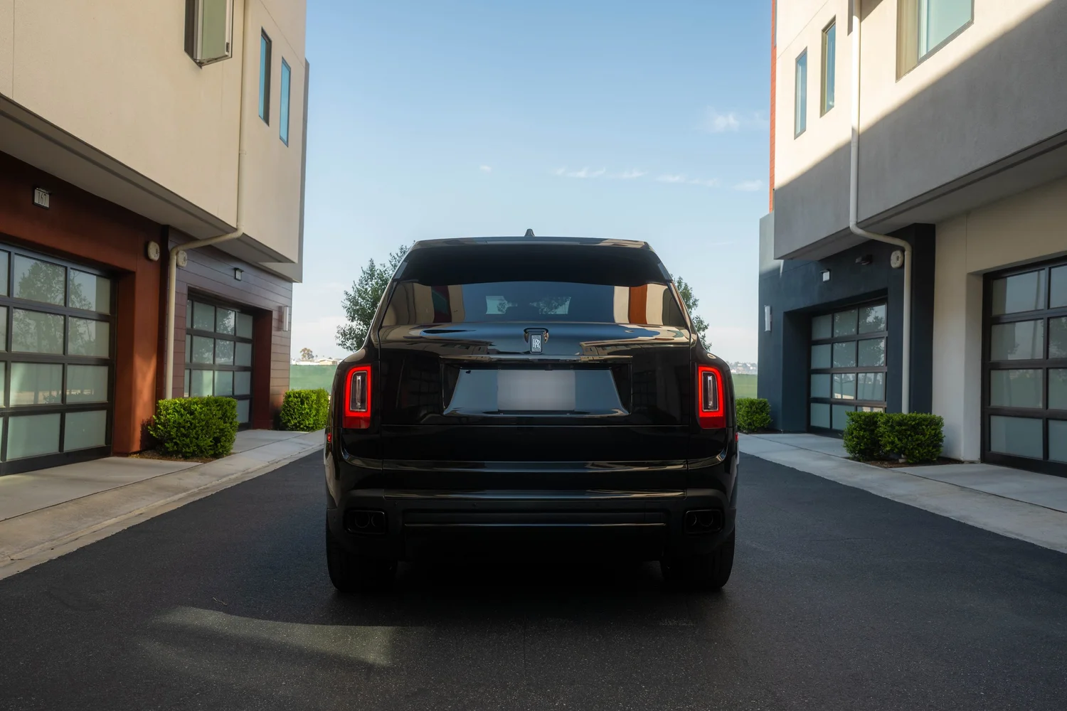 Black Rolls-Royce Cullinan Black Badge with Two-Tone Wheels after Paint Protection Film (PPF), Window Tint and Ceramic Coating, low-angle rear view