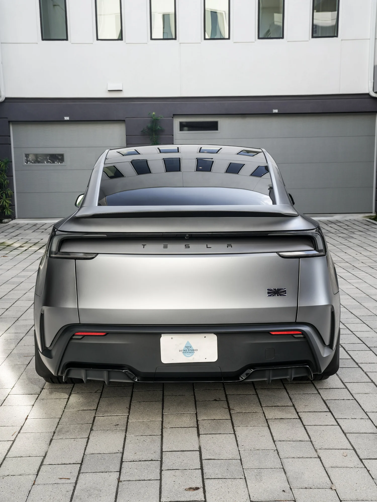 2026 Tesla Model Y Performance centered rear view after full XPEL STEALTH PPF and baby blue brake caliper repaint