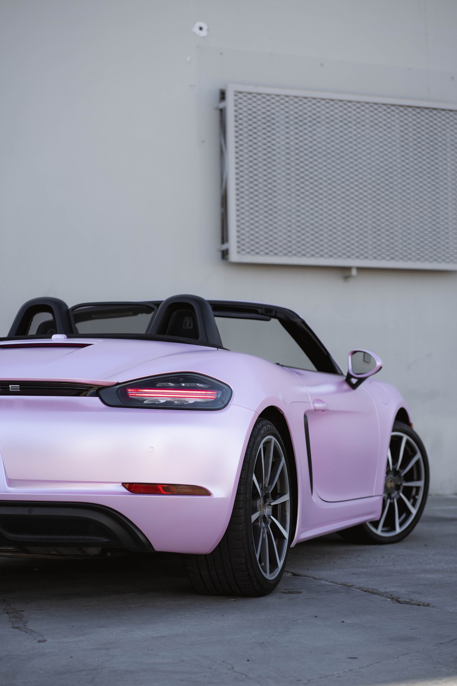 Porsche 718 Boxster Matte Purple Pink after Vinyl Wrap, low-angle front view