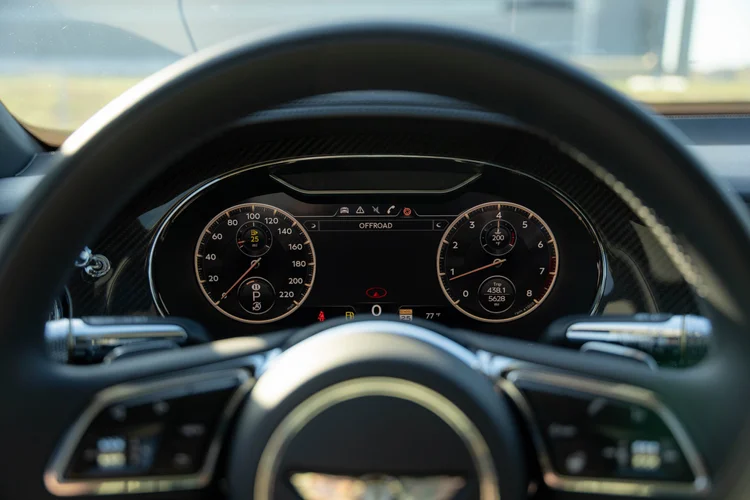 Instrument gauges framed by the dark Bentley steering wheel.