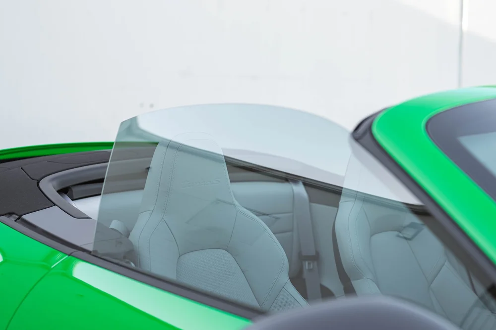Signal Green Porsche 911 Turbo S, raised side glass beside light seats with Turbo S embroidery