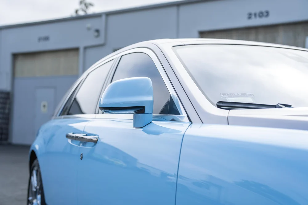 Rolls-Royce Ghost — side glass, mirror and adjacent door-panel reflections in a landscape detail