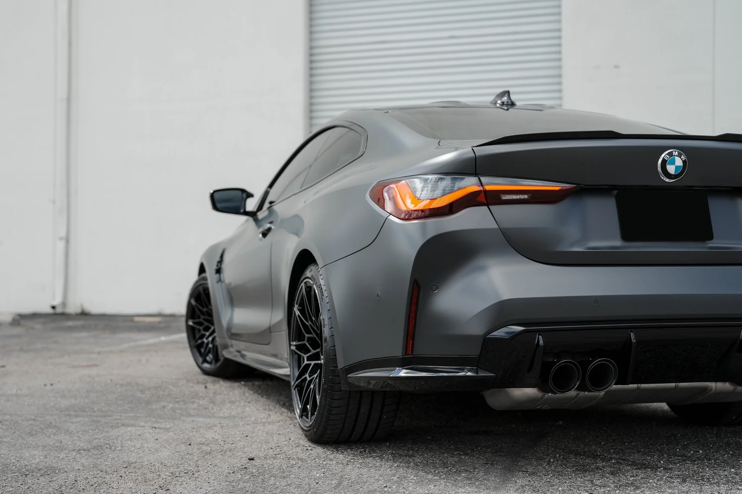Black BMW M4 after Matte PPF, Window Tint and Ceramic Coating, rear-quarter and wheel view