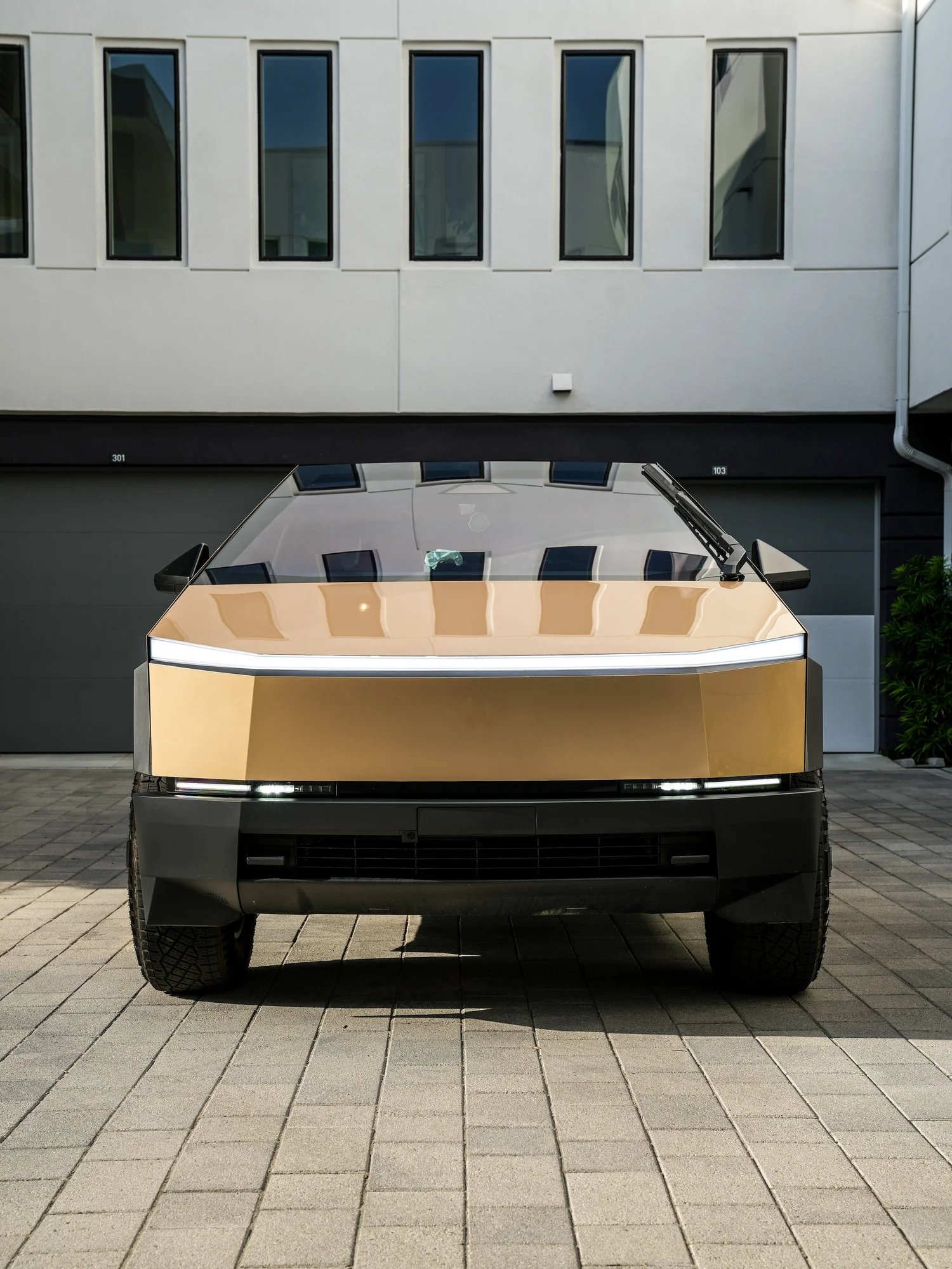 Tesla Cybertruck Milan Gold after Paint Protection Film (PPF) and Window Tint, low-angle rear view