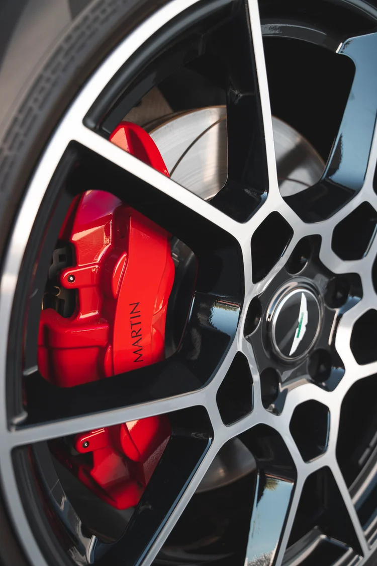Close wheel view with a red caliper and the silver-edged spoke pattern.