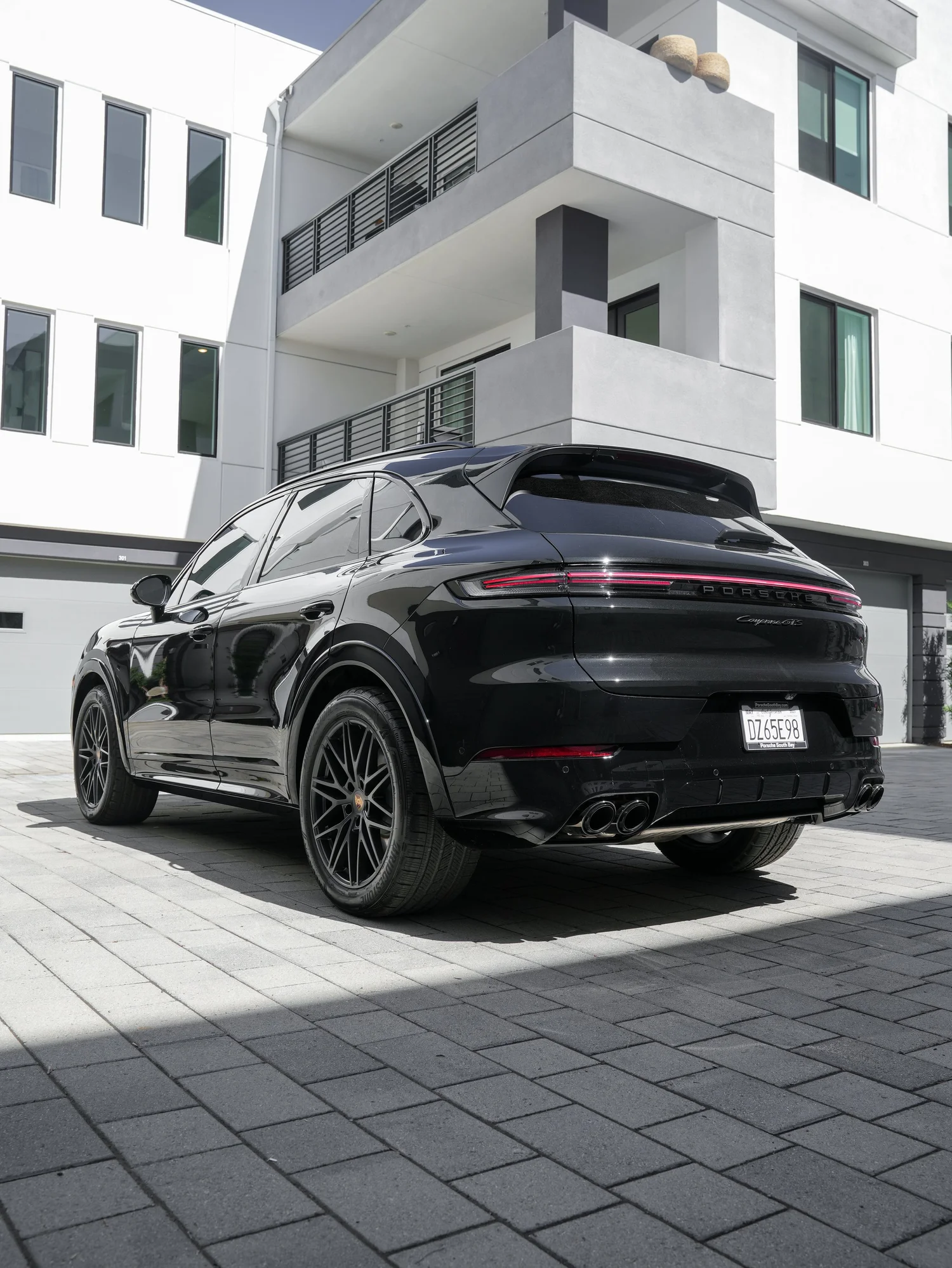 Black Porsche Cayenne GTS after Paint Protection Film (PPF), Window Tint and Ceramic Coating, rear-left three-quarter view