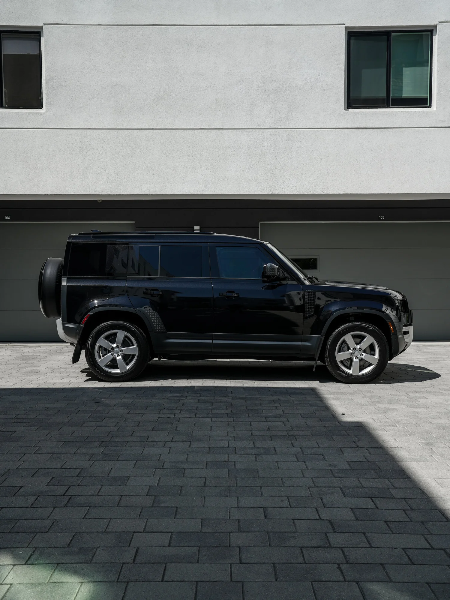 Land Rover Defender after Paint Protection Film (PPF) and Window Tint, left-side profile