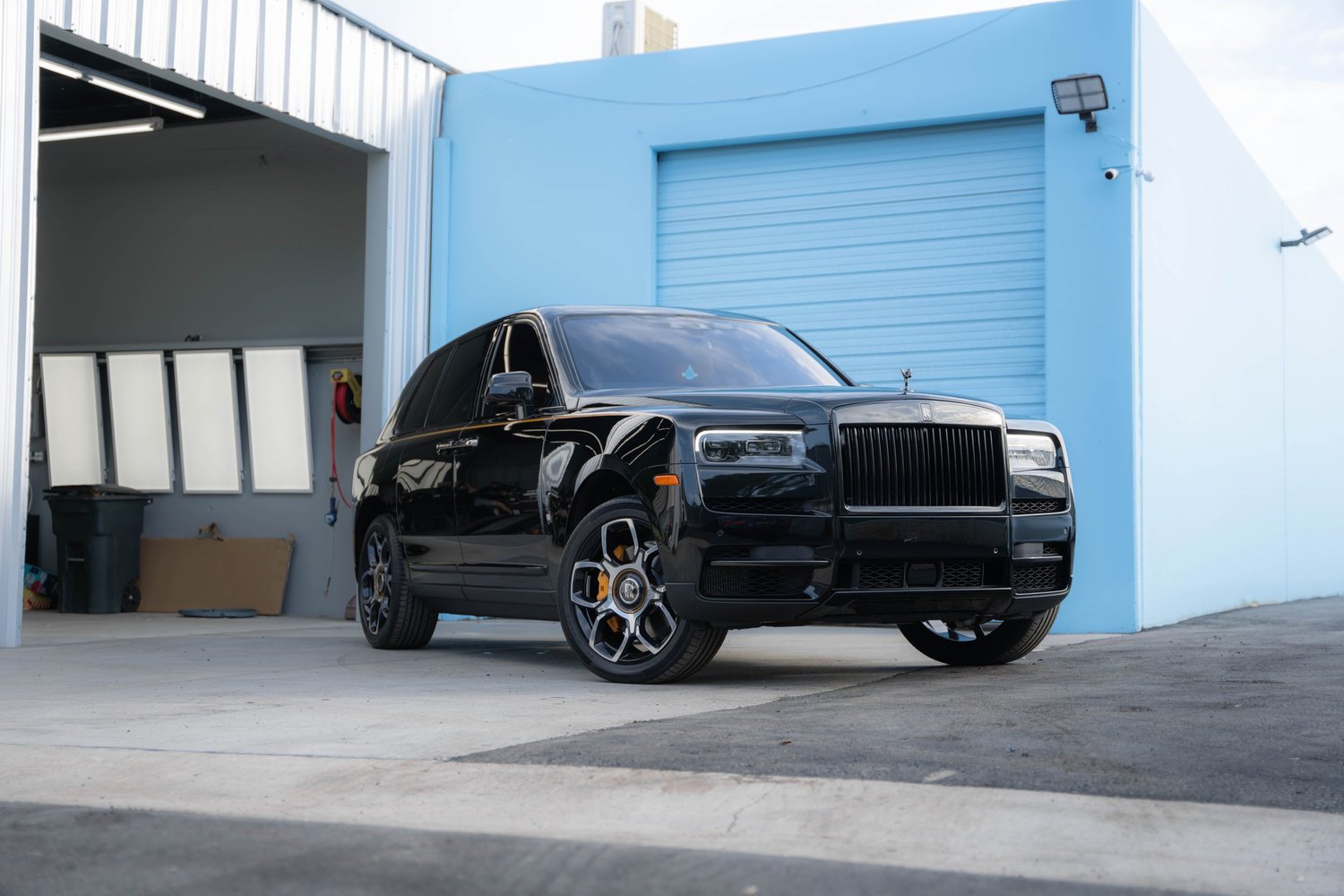 Black Rolls-Royce Cullinan Black Badge with Yellow Brake Calipers after Paint Protection Film (PPF), Window Tint and Ceramic Coating, alternate angle of front-right three-quarter view