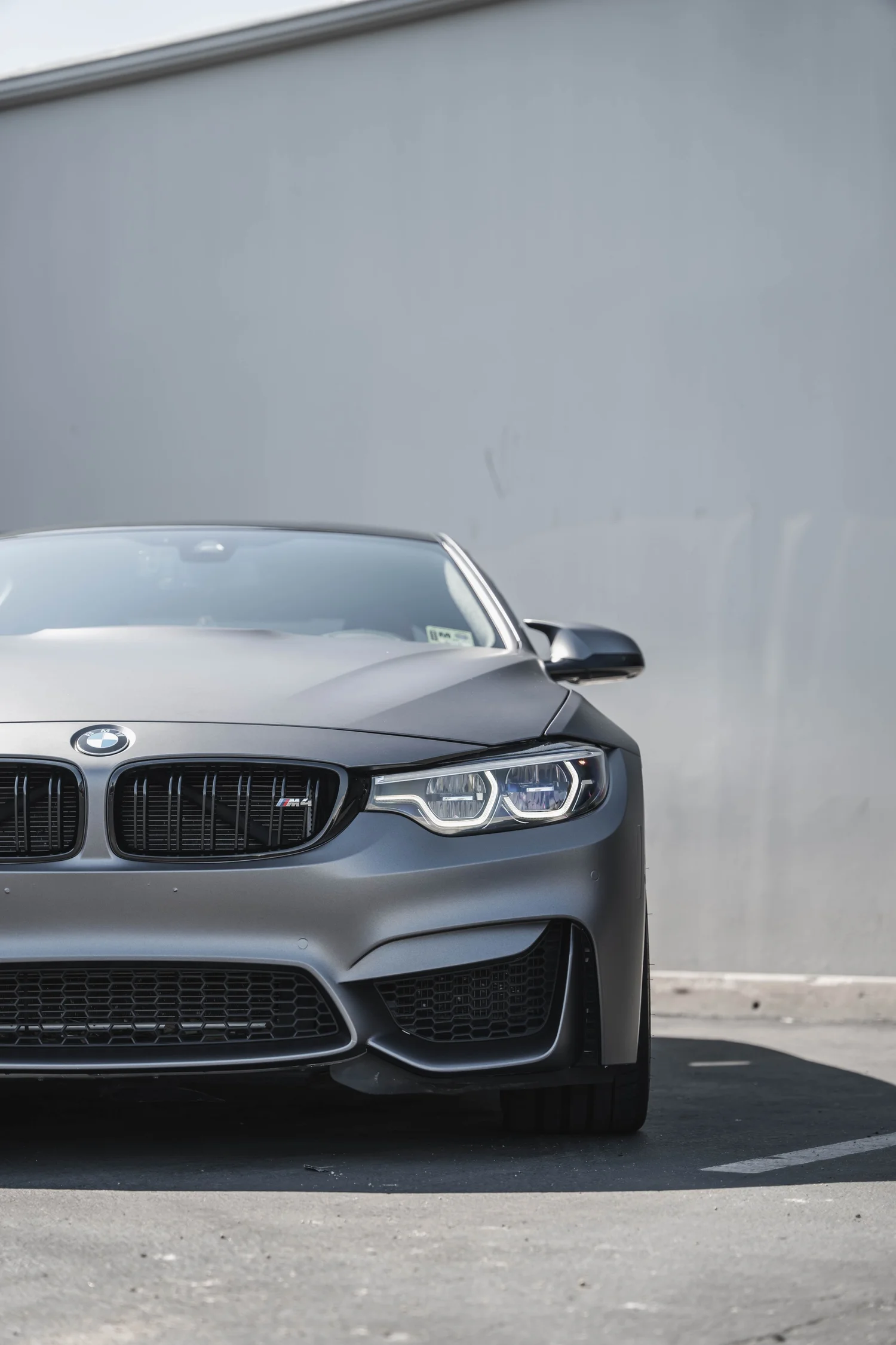 BMW M4 Matte Grey after Vinyl Wrap, low-angle front view