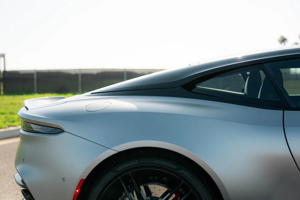 Matte-finish DBS rear quarter with the rear wheel, slim taillight and triangular side glass