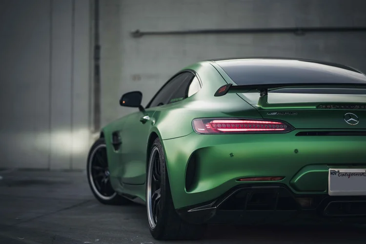 Close rear three-quarter view showing the green rear fender, black wing and red lamps with the rear end cropped.