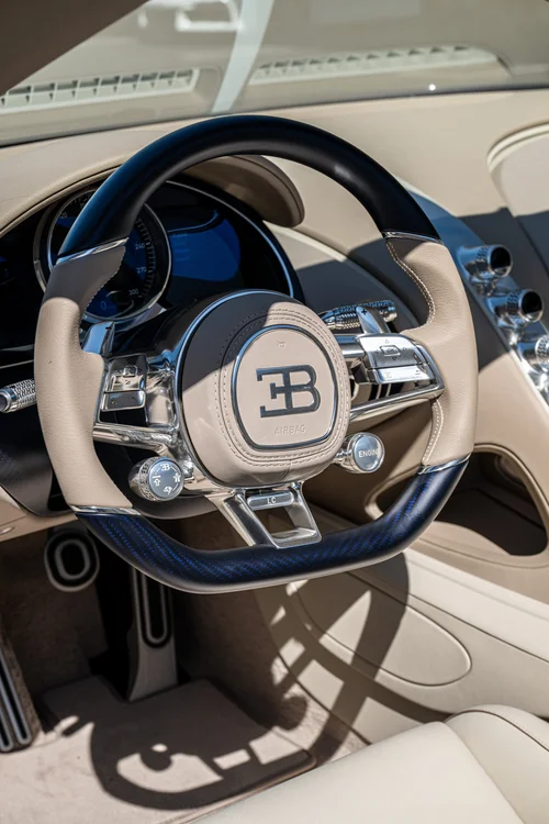 Bugatti W16 Mistral steering wheel with blue carbon trim, EB emblem and polished driver controls