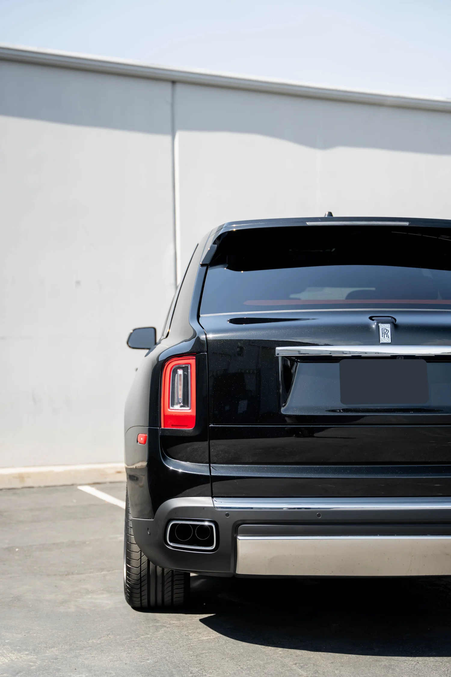 Black Rolls-Royce Cullinan with Chrome Exterior Trim after Paint Protection Film (PPF), Window Tint and Ceramic Coating, rear body and taillight view