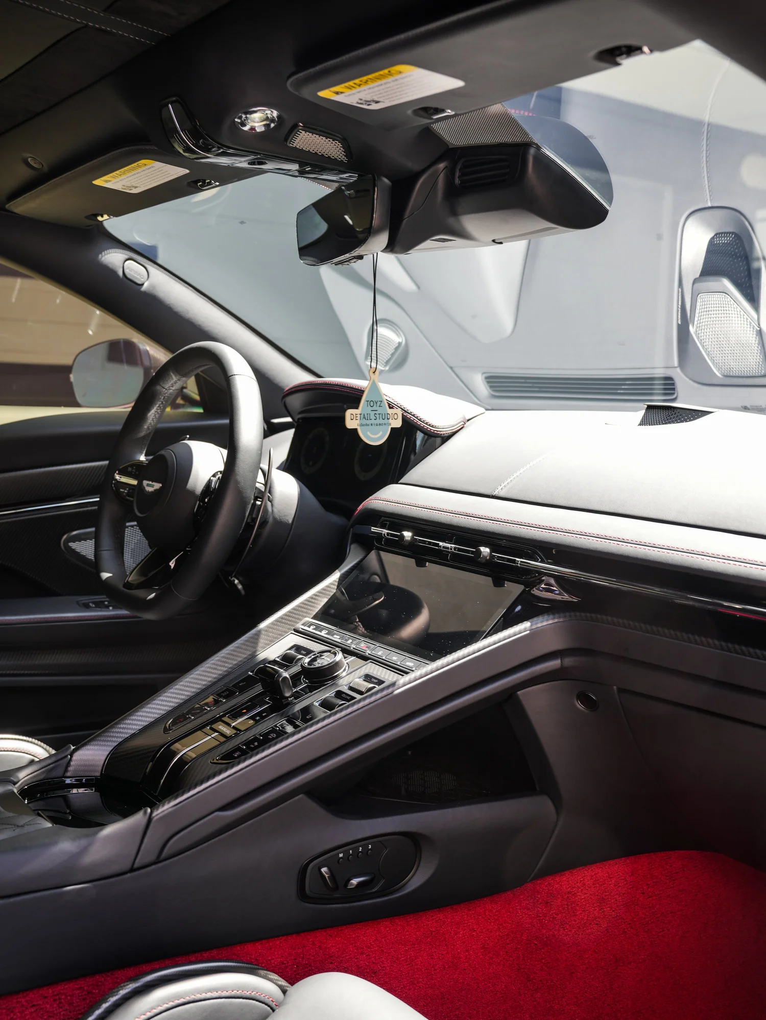 Aston Martin DB12 cockpit and center console after full exterior PPF, window tint and ceramic coating