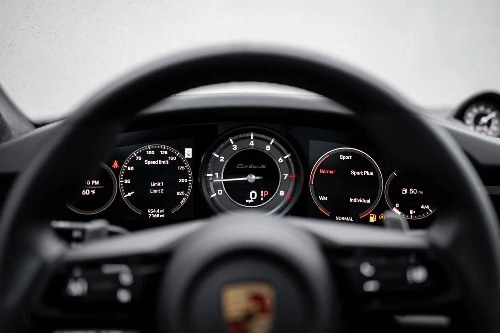 Porsche 911 Turbo S instrument cluster viewed through the steering wheel