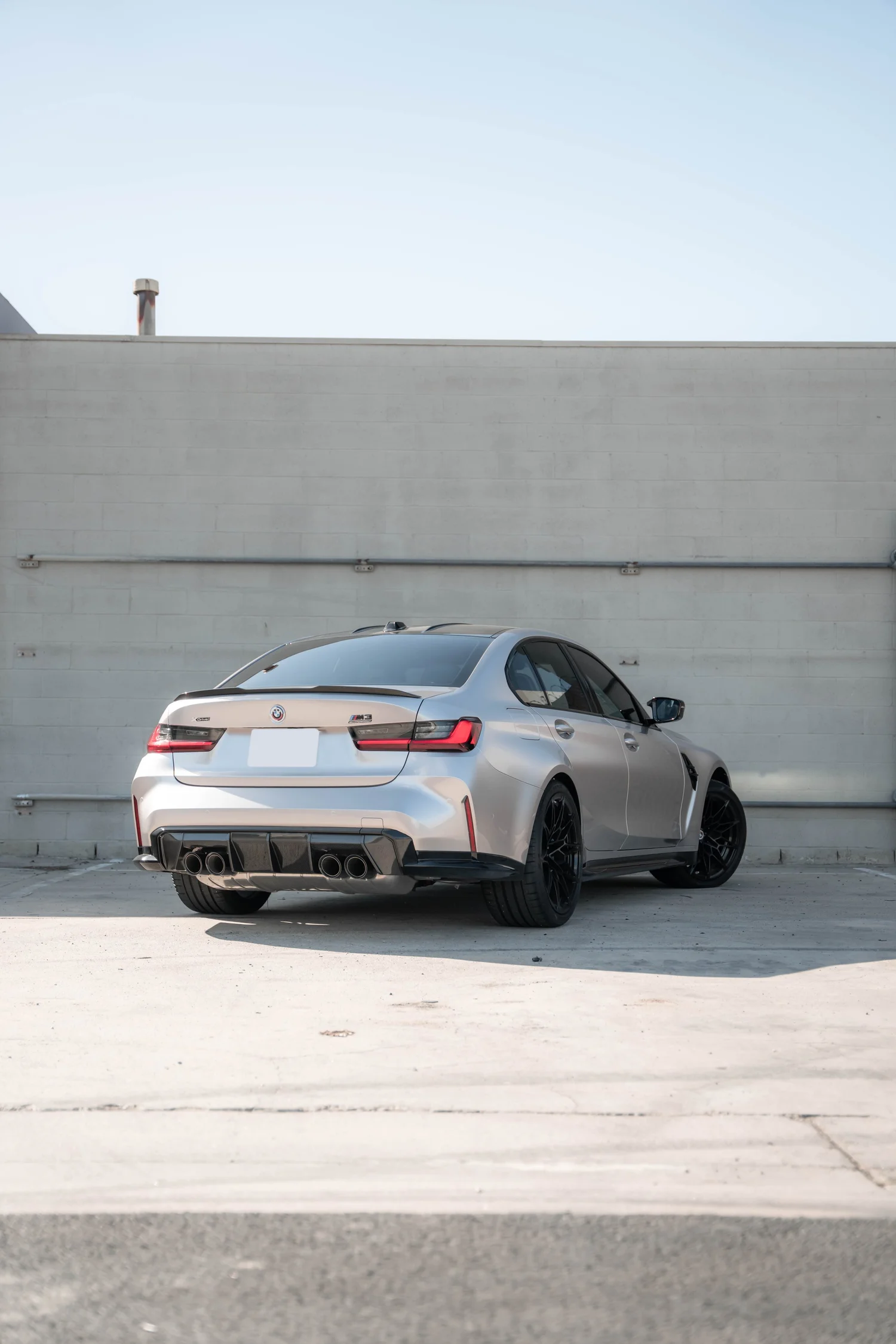 BMW M3 Gloss Silver Vinyl Wrap, rear three-quarter view