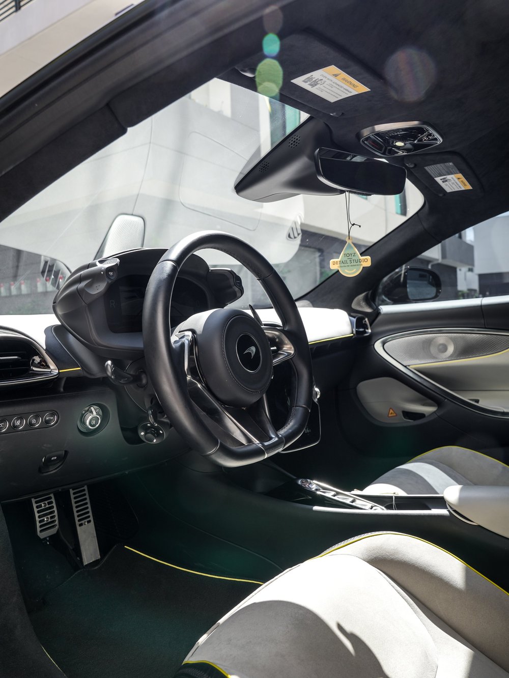 Artura steering wheel and instrument panel seen through the open door