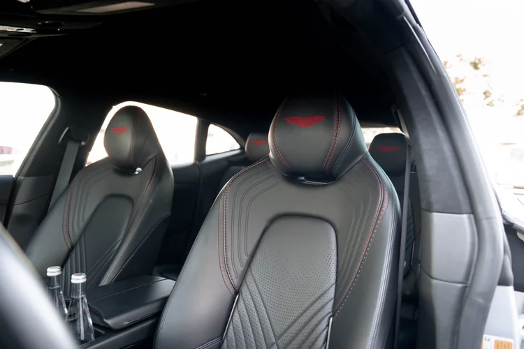Black front seats with red stitching and wing emblems on the headrests.