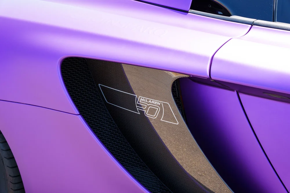 McLaren MP4-12C — side air intake and adjacent body panel with a small emblem