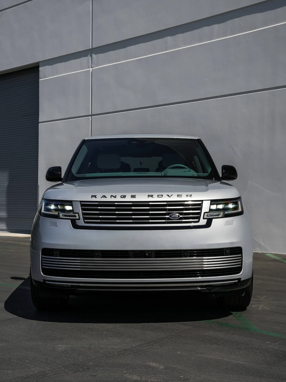 Straight front view of the silver Range Rover SV showing both mirrors, headlights and grille.