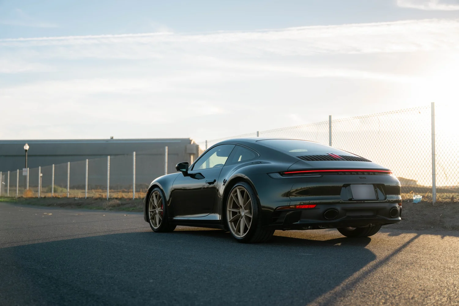 Porsche 911 Carrera Wrapped in British Green after Vinyl Wrap, rear-left three-quarter view