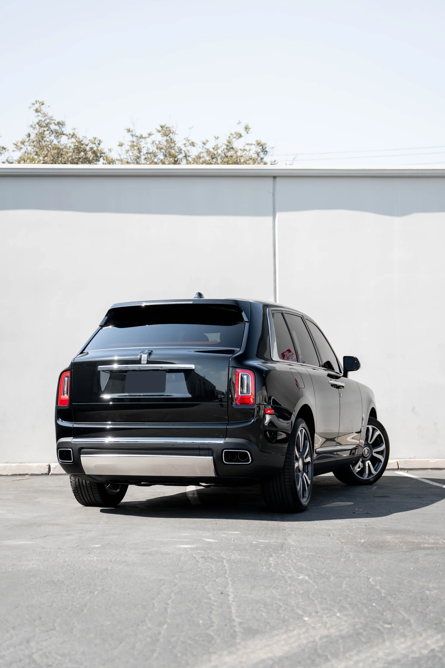 Black Rolls-Royce Cullinan with Chrome Exterior Trim after Paint Protection Film (PPF), Window Tint and Ceramic Coating, rear-left three-quarter view