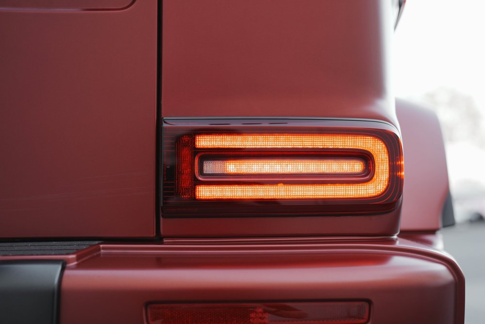 Illuminated rectangular G63 rear lamp set into the red body above the rear bumper