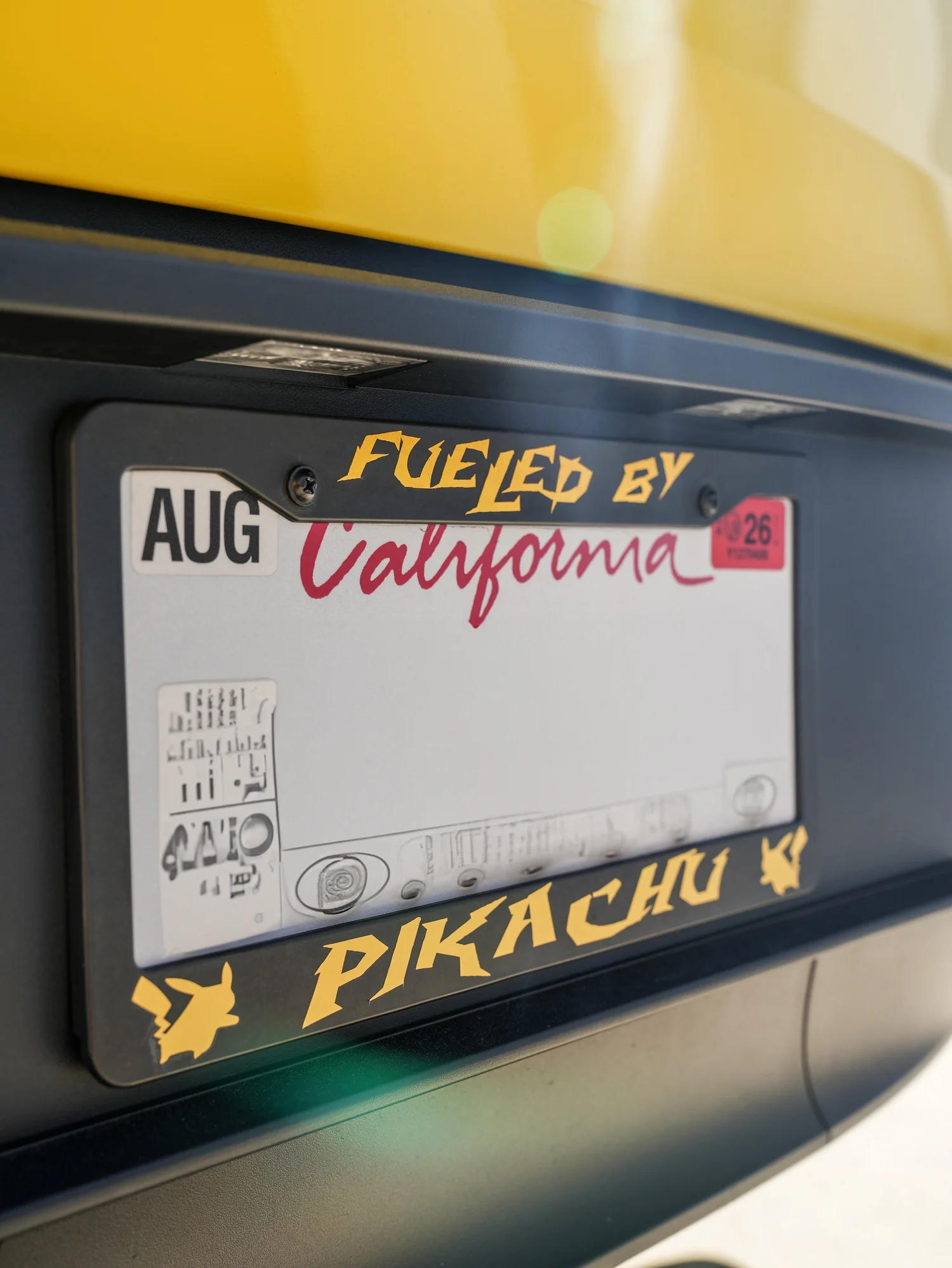 Tesla Model Y Vegas Yellow wrap with Pikachu-themed license plate frame detail