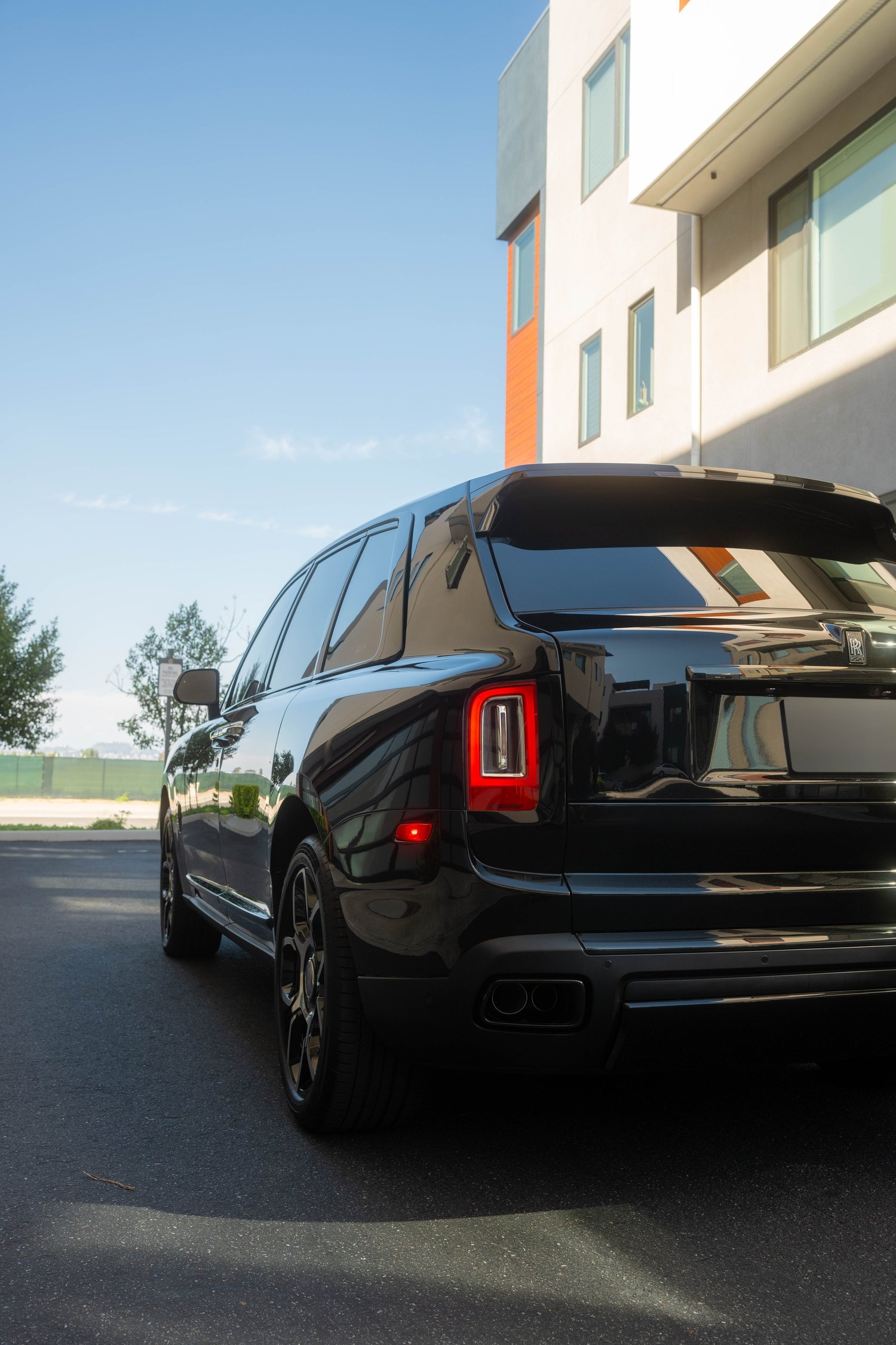 Black Rolls-Royce Cullinan Black Badge with Two-Tone Wheels after Paint Protection Film (PPF), Window Tint and Ceramic Coating, rear-left three-quarter view