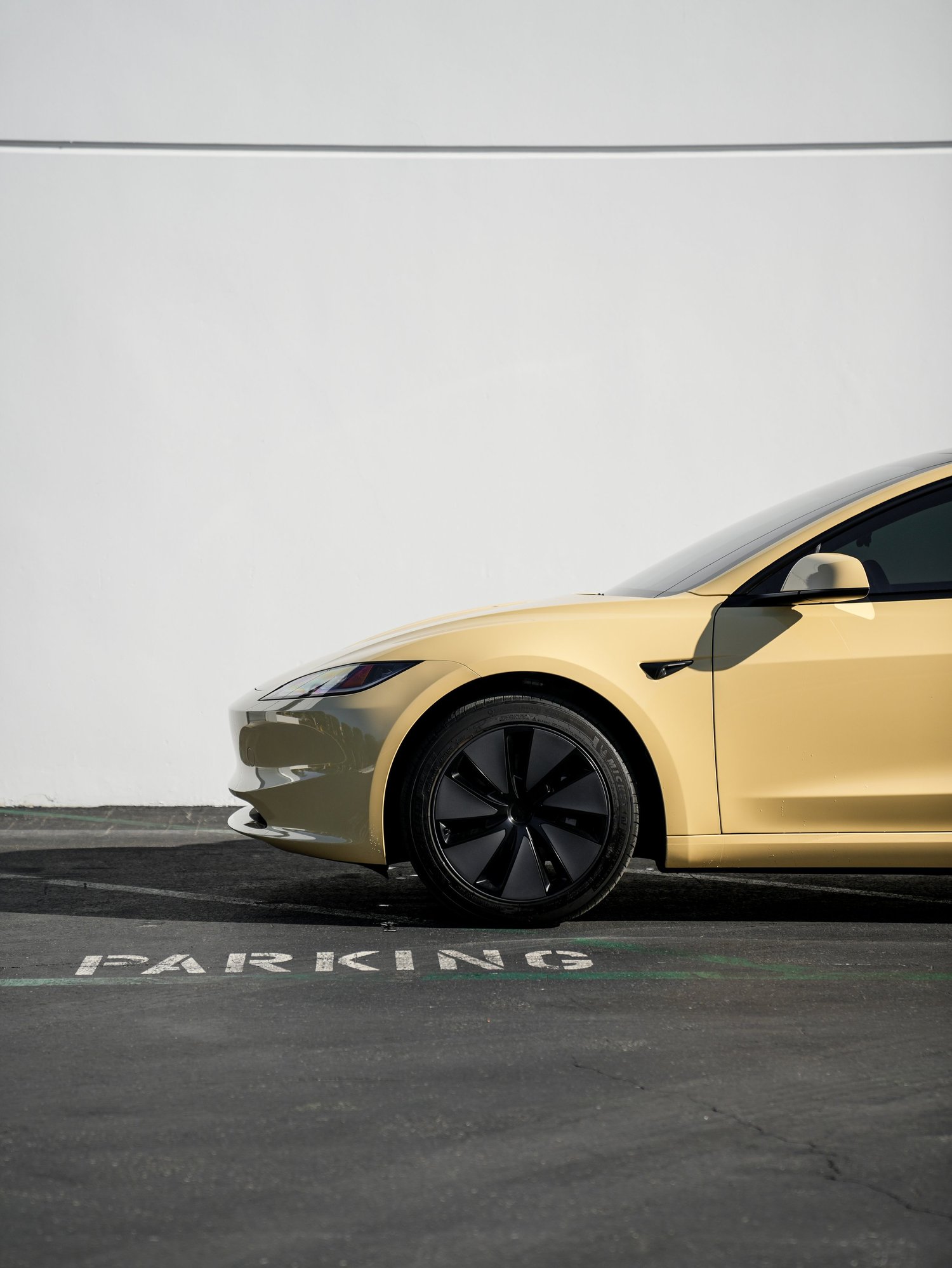 Tesla Model 3 Sunrise Yellow after Vinyl Wrap, low-angle front view