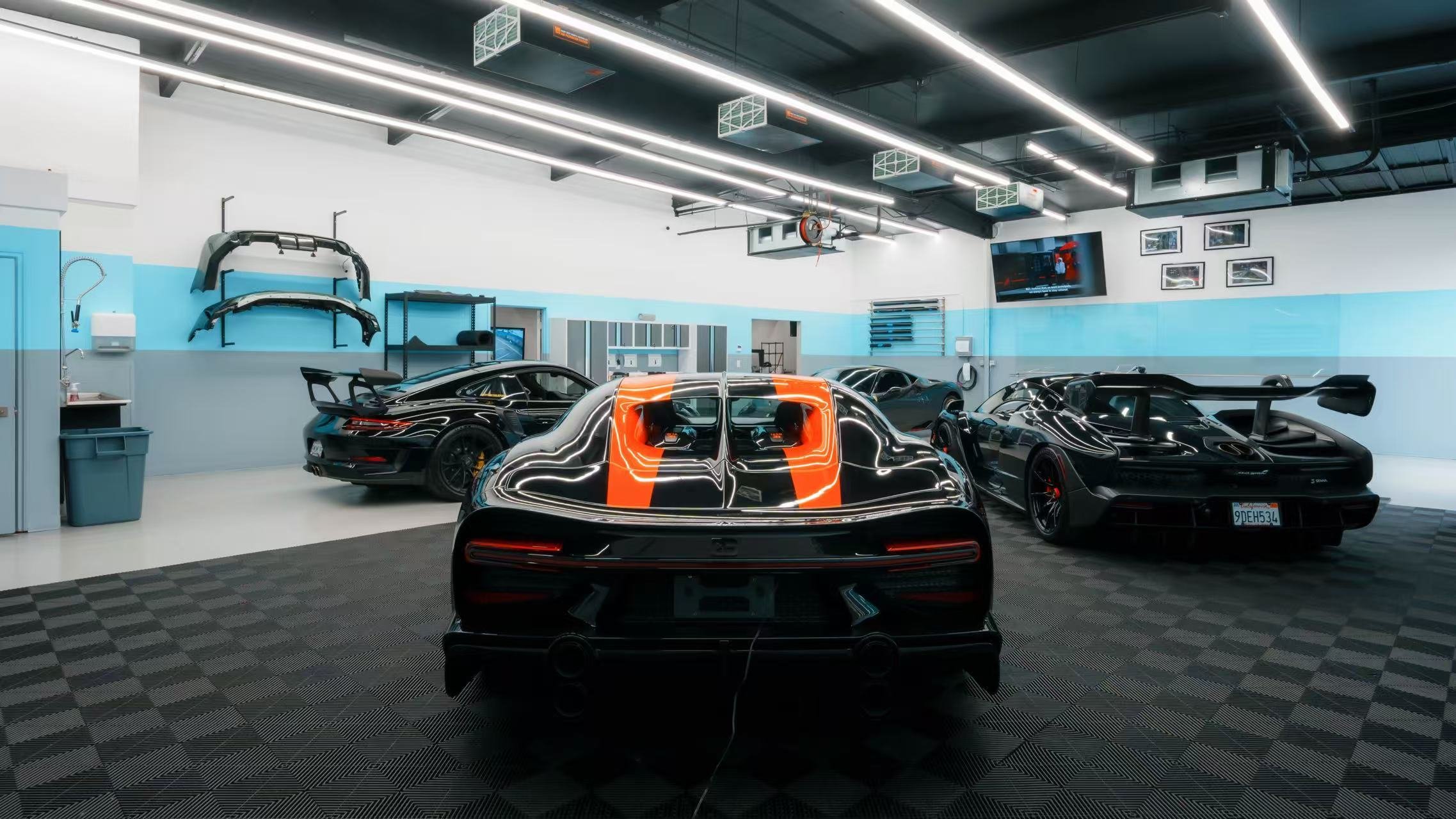 High-performance vehicles inside Toyz Detail Studio's indoor installation studio in Irvine