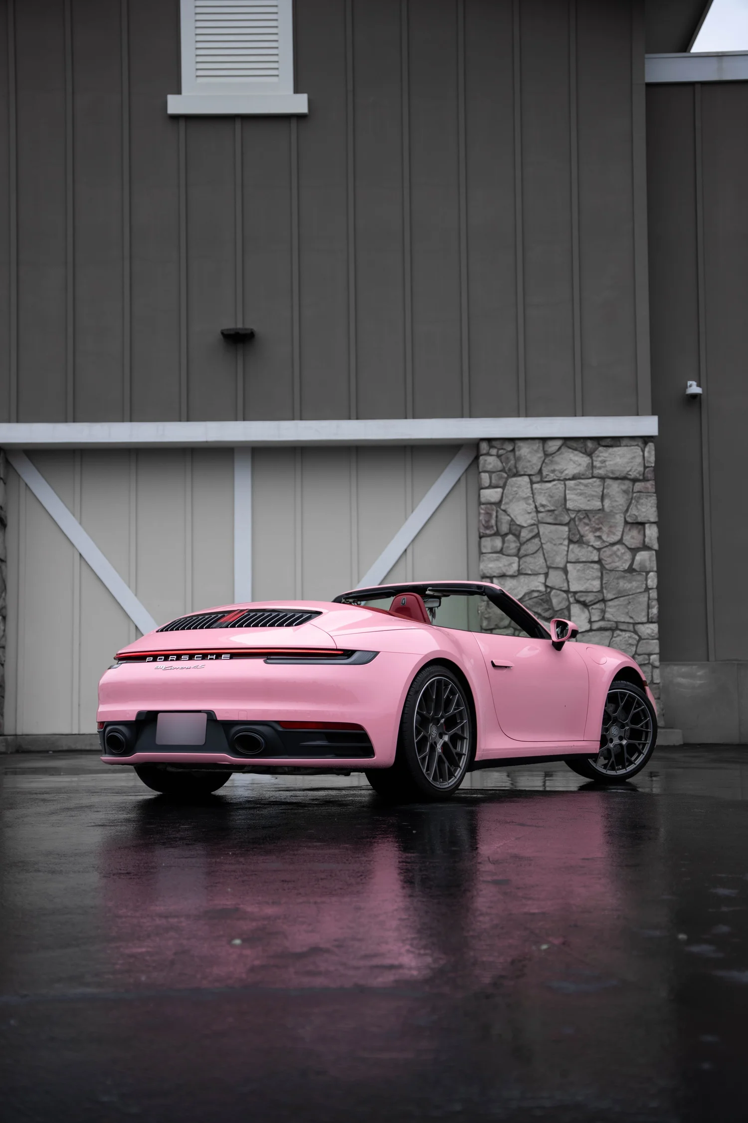 Porsche 911 Sakura Pink after Vinyl Wrap, wide indoor studio view