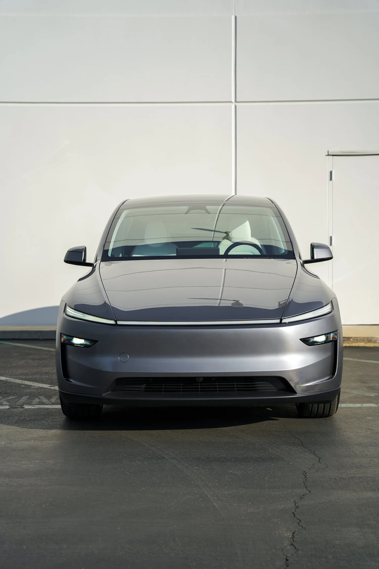 Grey Tesla Model Y after Paint Protection Film (PPF), Window Tint and Ceramic Coating, direct front view