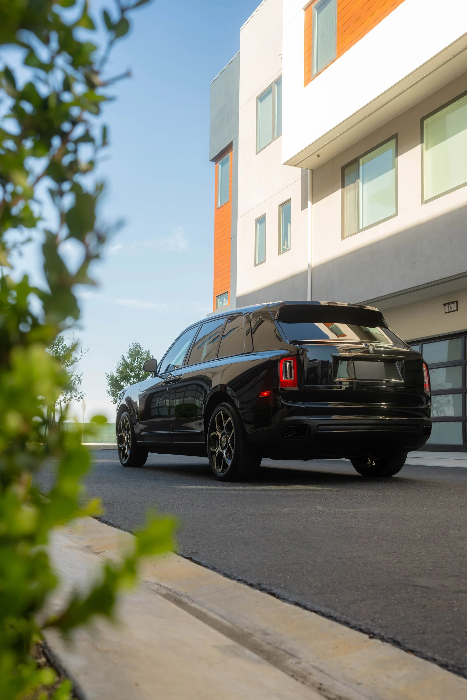 Black Rolls-Royce Cullinan Black Badge with Two-Tone Wheels after Paint Protection Film (PPF), Window Tint and Ceramic Coating, wide rear three-quarter view