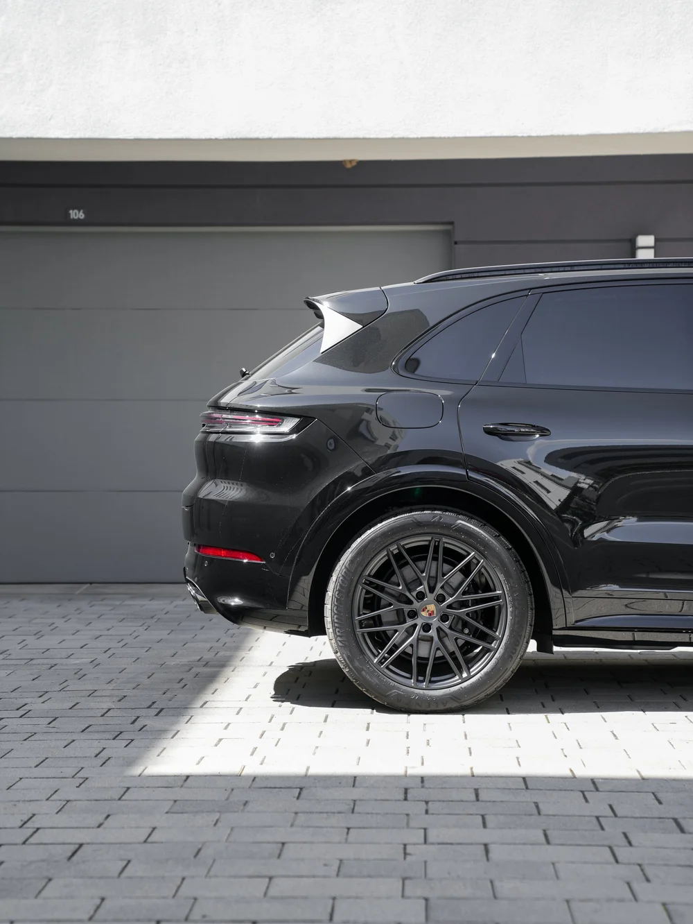 Black Cayenne GTS rear wheel and quarter panel with side glass, fuel door and tail-lamp detail.