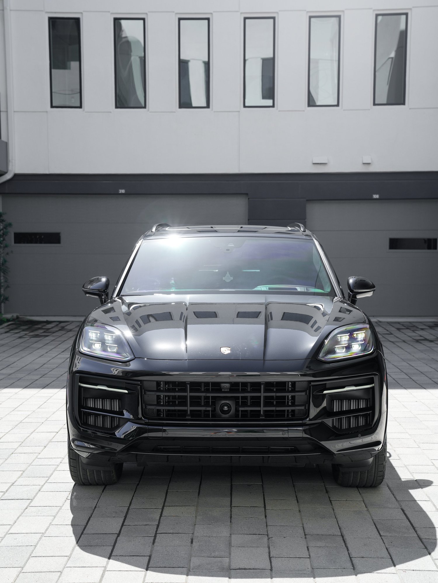 Black Porsche Cayenne GTS after Paint Protection Film (PPF), Window Tint and Ceramic Coating, direct front view