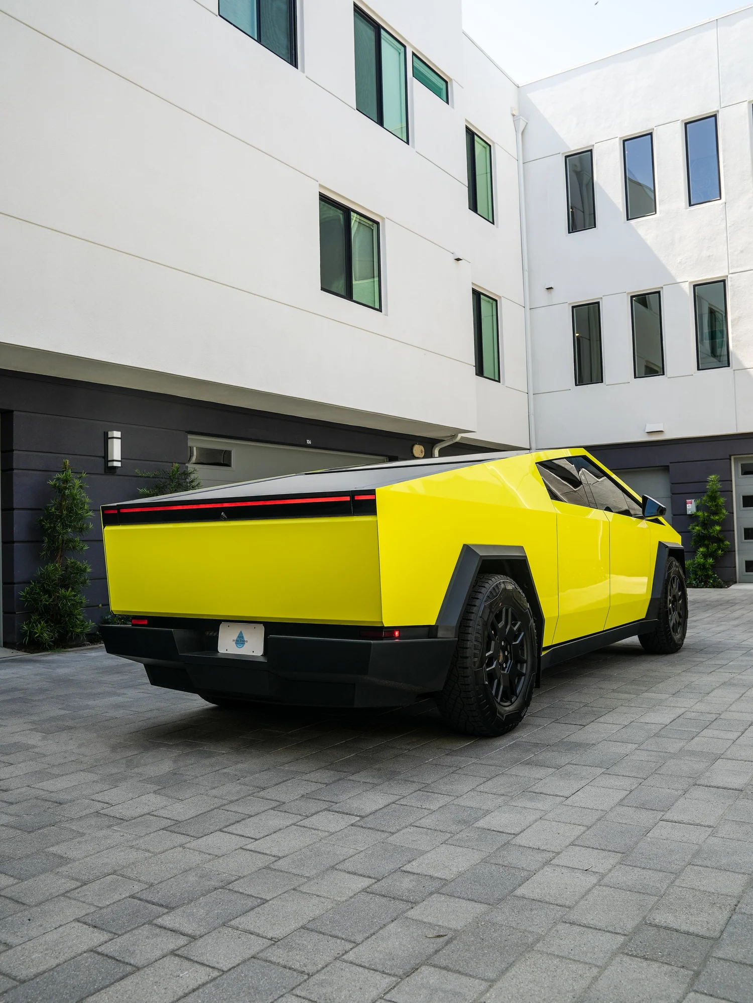 Tesla Cybertruck Inozetek Racing Yellow after Window Tint and Vinyl Wrap, rear-right three-quarter view