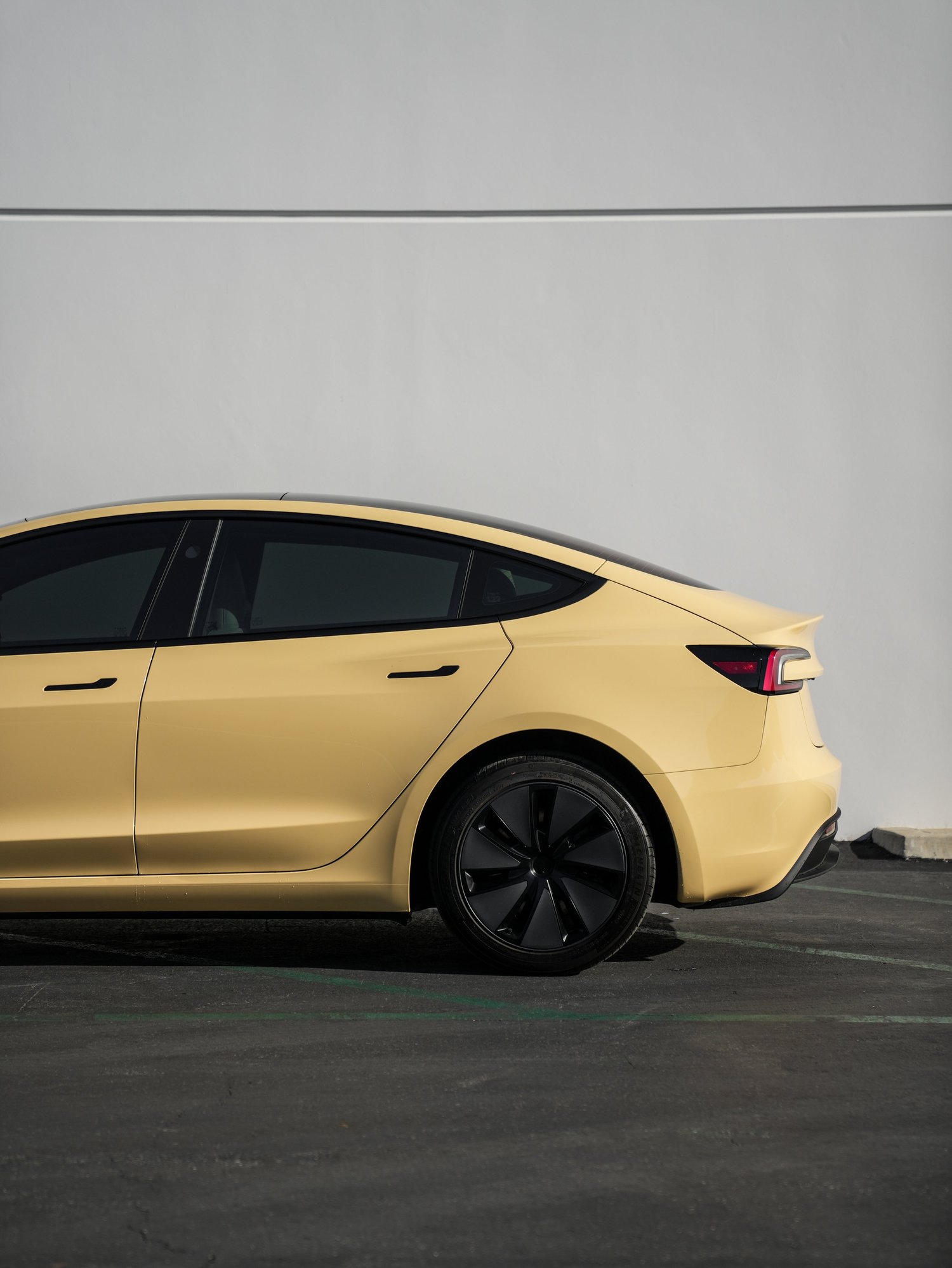 Tesla Model 3 Sunrise Yellow after Vinyl Wrap, rear-right three-quarter view
