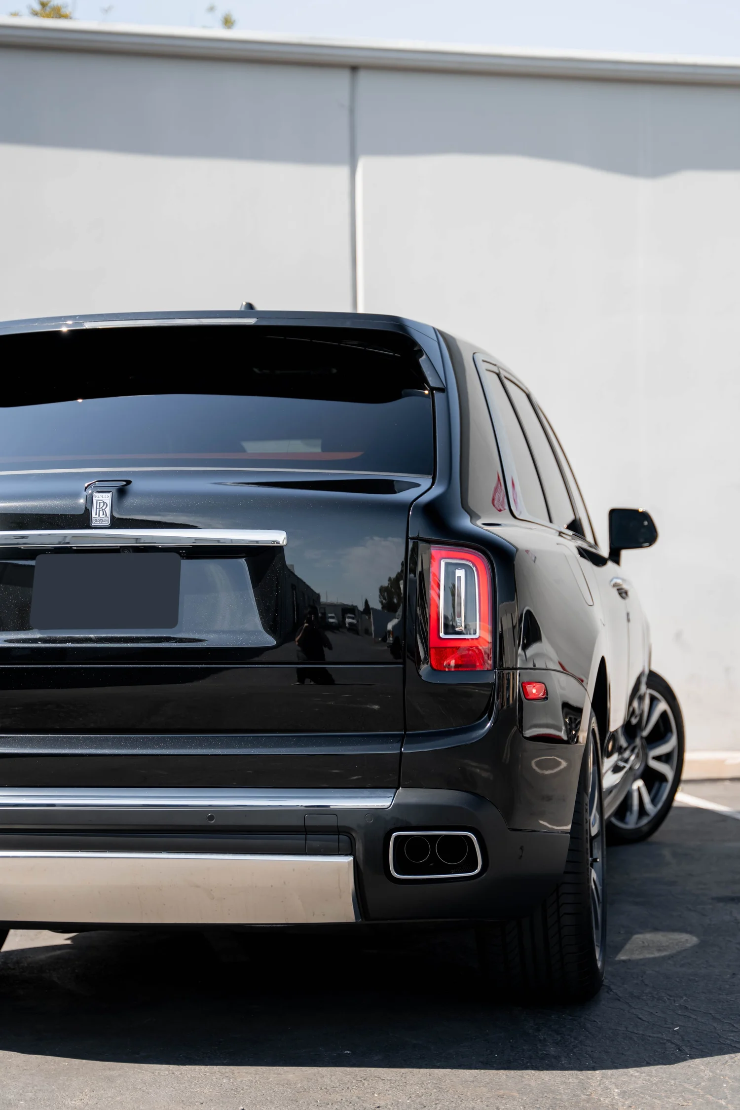 Black Rolls-Royce Cullinan with Chrome Exterior Trim after Paint Protection Film (PPF), Window Tint and Ceramic Coating, close rear view