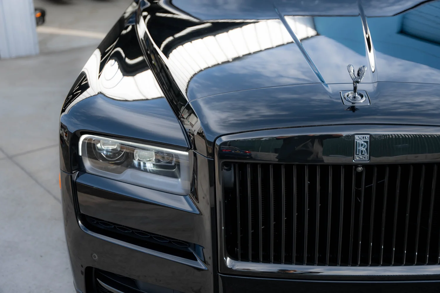 Black Rolls-Royce Cullinan Black Badge with Yellow Brake Calipers after Paint Protection Film (PPF), Window Tint and Ceramic Coating, front grille detail