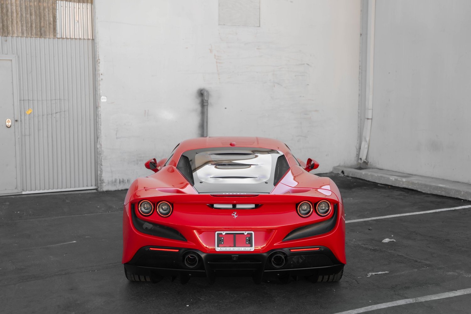 Rosso Corsa Ferrari F8 after Paint Protection Film (PPF), Window Tint and Ceramic Coating, low-angle rear view
