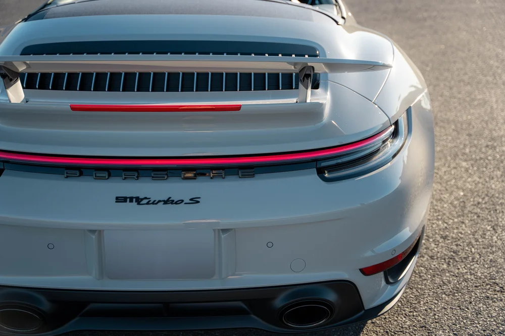Chalk Porsche 911 Turbo S, high rear detail of spoiler, light bar, Turbo S badge and bodywork