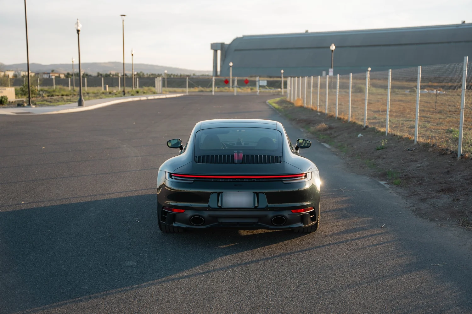 Porsche 911 Carrera Wrapped in British Green after Vinyl Wrap, low-angle rear view