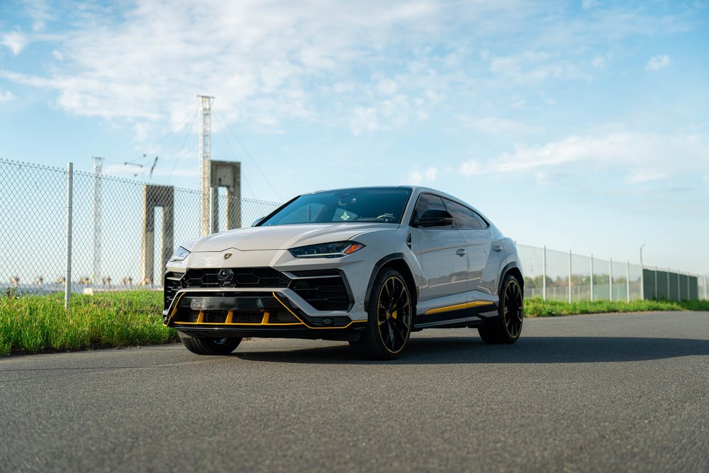 Lamborghini Urus with Chalk vinyl wrap, complete wide front three-quarter view with yellow lower accents